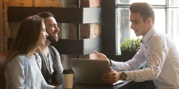 Three people discussing home loan programs