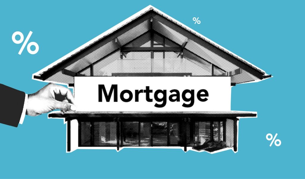 a person holding a sign displaying the word mortgage