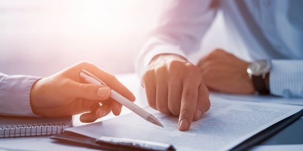 Two people looking at mortgage loan programs