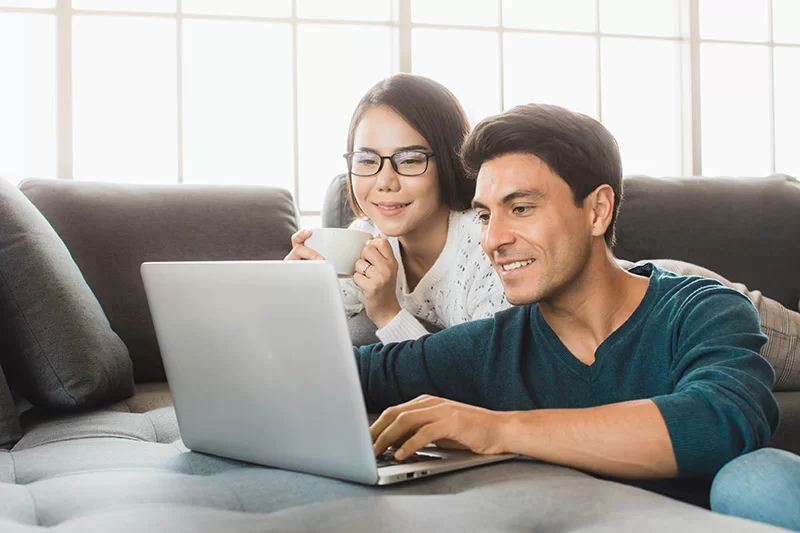 Two people researching types of home mortgage loans