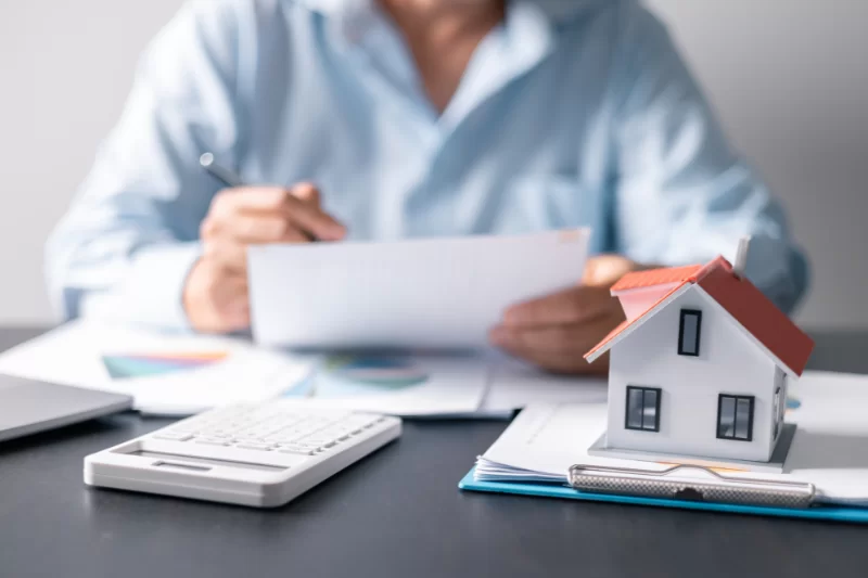 A person looking over paperwork for an asset utilization mortgage