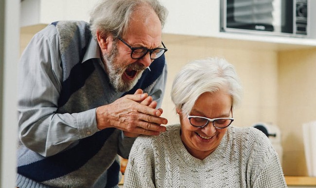 An elderly couple celebrates the discovery of their loan approval