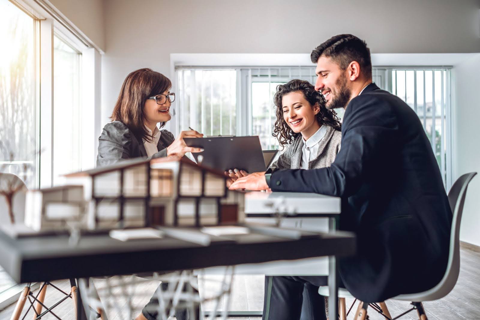 An investment property loan broker advising a couple about loan options